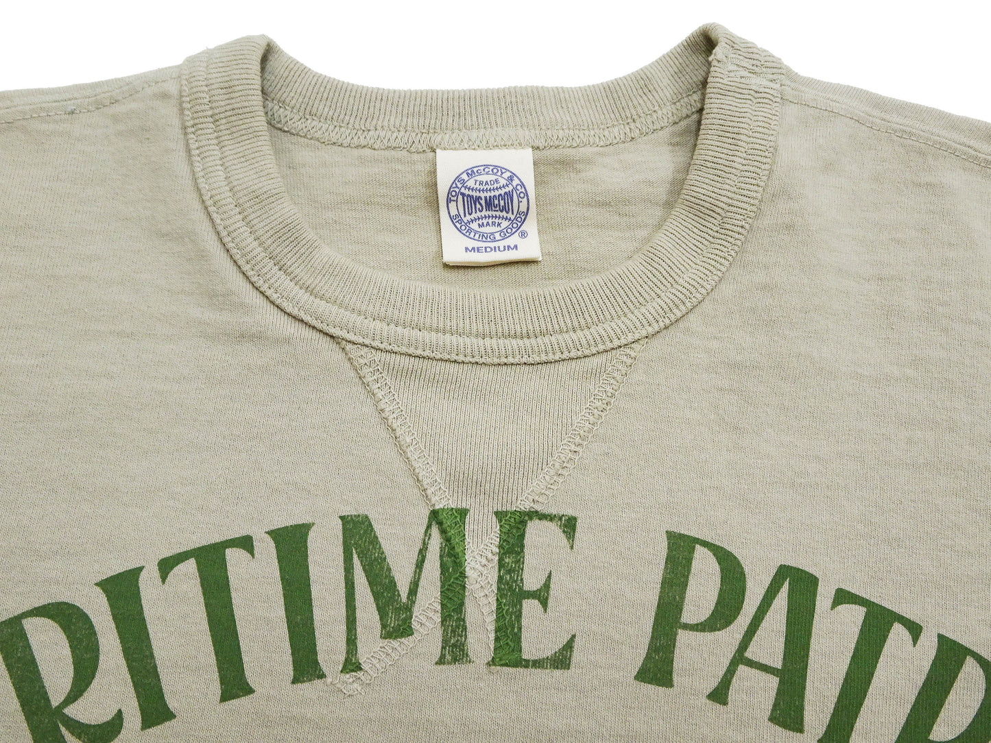 TOYS McCOY Men's Felix the Cat U.S. Navy Graphic Short Sleeve T-Shirt - Loopwheel Tubular Jersey, Garment Dyed, Made in Japan (TMC2601 041 Muted Sand Beige)